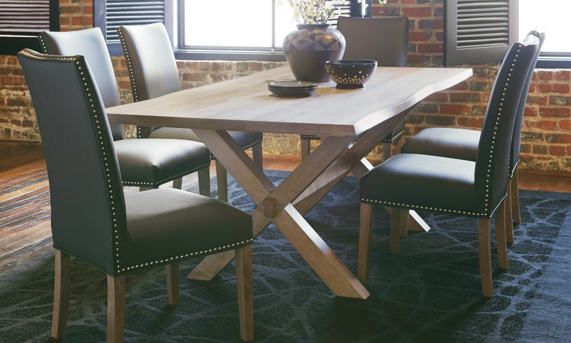 Beautiful customizable dining room table with natural live edge on the table edge and black leather chairs