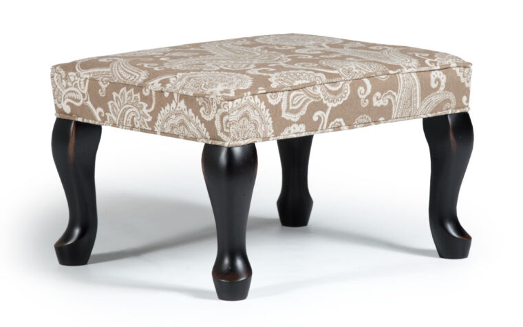 0082 queen anne ottoman is a victorian styled ottoman with a beige and white paisley pattern accented with antique black legs