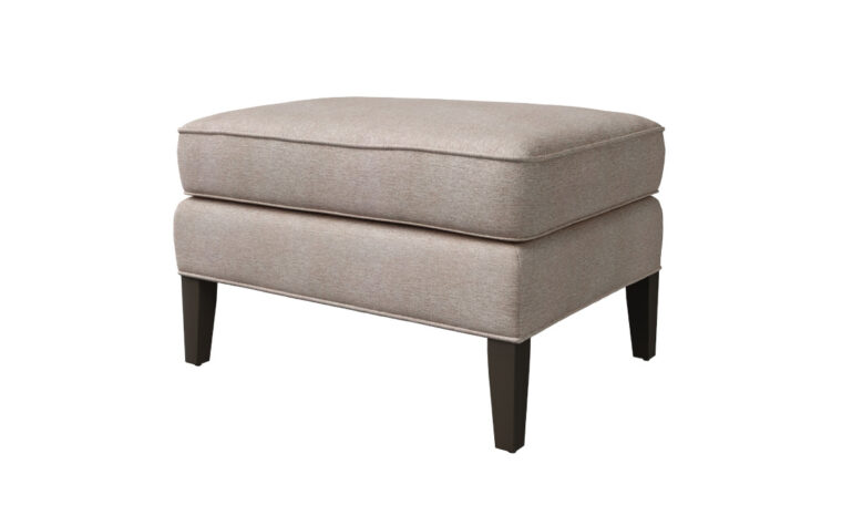 Angled shot of the Birkley Ottoman by Vogel in a taupe fabric cover with espresso legs
