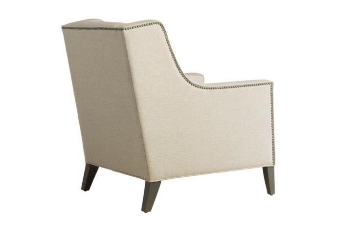 Back shot of the Eloise lounge chair by Vogel showcasing neutral fabric, espresso wood finish, and nail head trims