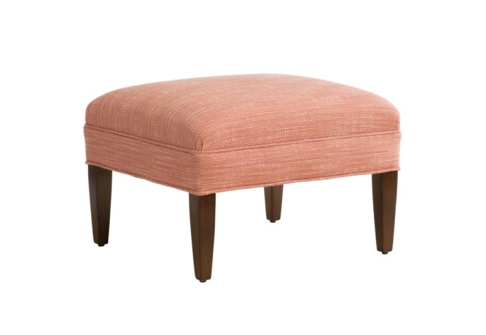 side angle of Stirling Ottoman by Vogel with red fabric and brown legs