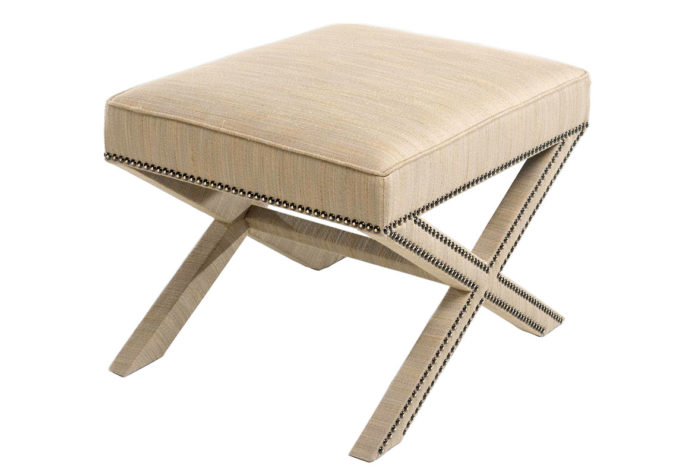x bench in beige fabric with nail head trim and covered base