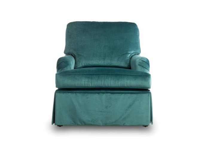 tesssa chair is skirted and shown in a blue velvet fabric