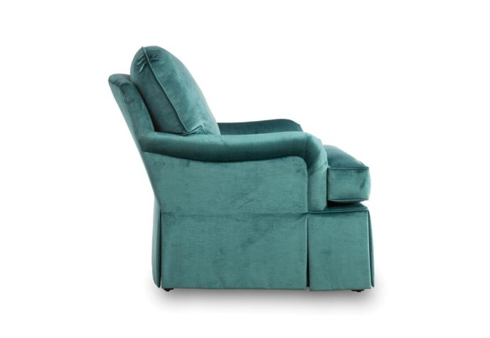 side angle of tesssa chair is skirted and shown in a blue velvet fabric