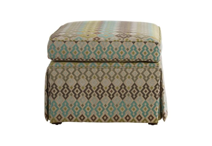 Tessa ottoman by Vogel with a skirt and a brown and blue fabric cover