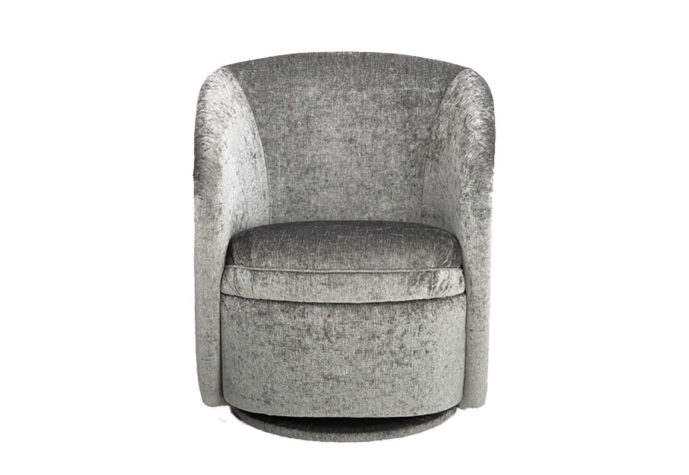 Front shot of the Ruby swivel chair by Vogel in a silvery green velvet fabric