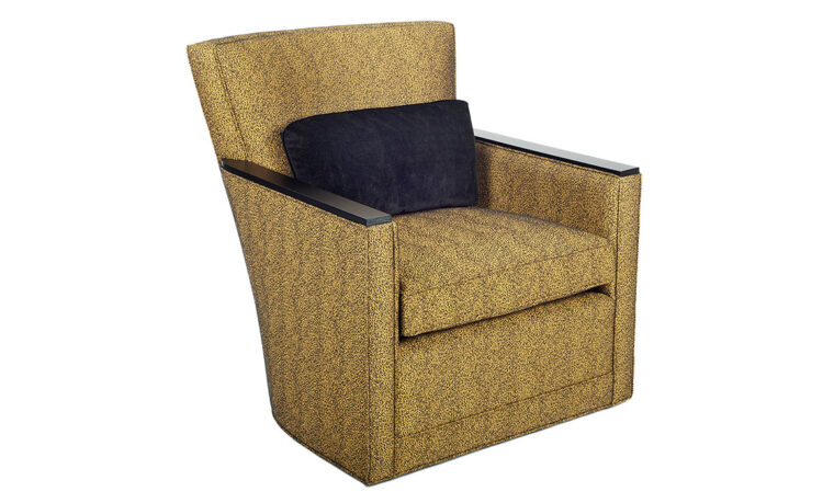 Angled shot of the Max Swivel Chair from Vogel by Chervin in a mustard yellow fabric with espresso wood-top arms and a black kidney pillow