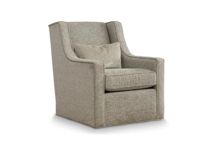Angled side view of the transitional Eloise swivel chair in beige fabric with metal nail head trim and lumbar pillow in same fabric