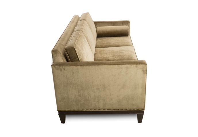 side view of 14107 sofa shown in velvet fabric with espresso wood finish and nailhead trim