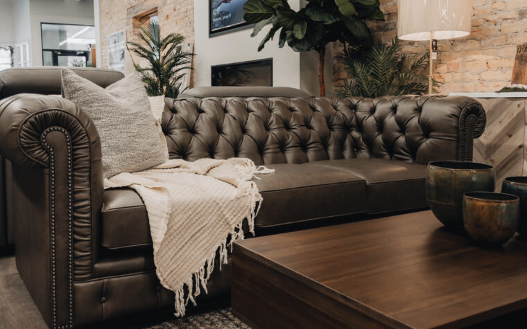 charcoal leather tufted sofa with nail head trim