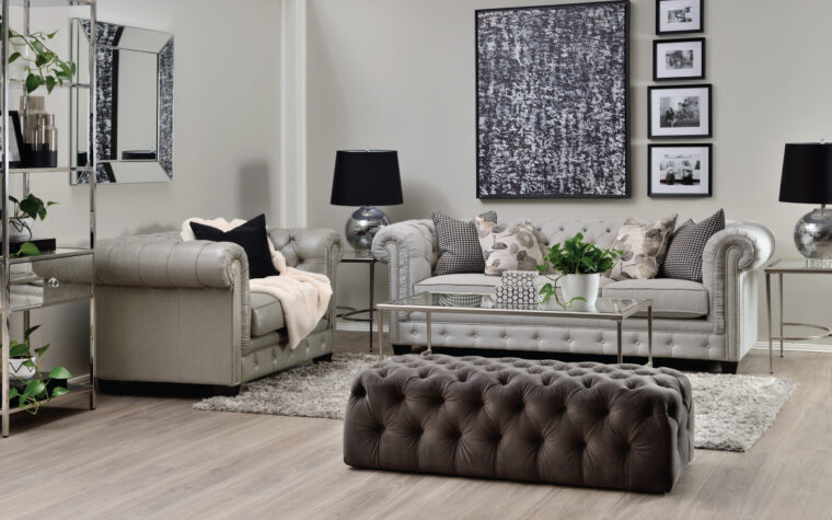 grey leather tufted sofa in living room with tufted ottoman