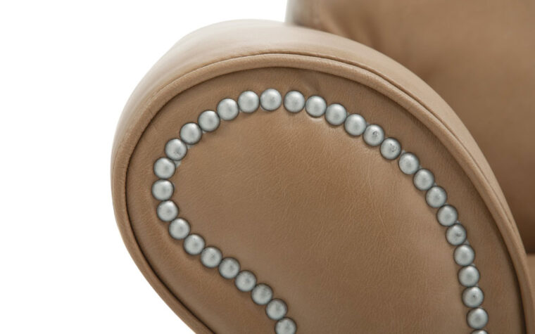 close up arm detail of rosebank chair is a relaxed casual club chair in a brown leather with nail head trim and piping on curved arm