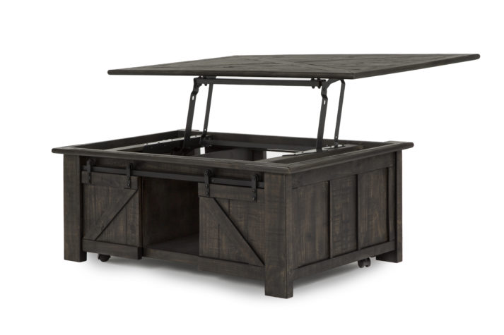 The Garret Lift Top Cocktail Table is constructed from pine solids, metal and casters and has a weathered charcoal finish