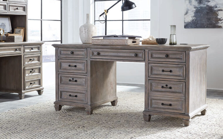 The Lancaster executive desk by Magnussen is constructed from pine veneer and has a dove tail grey finish