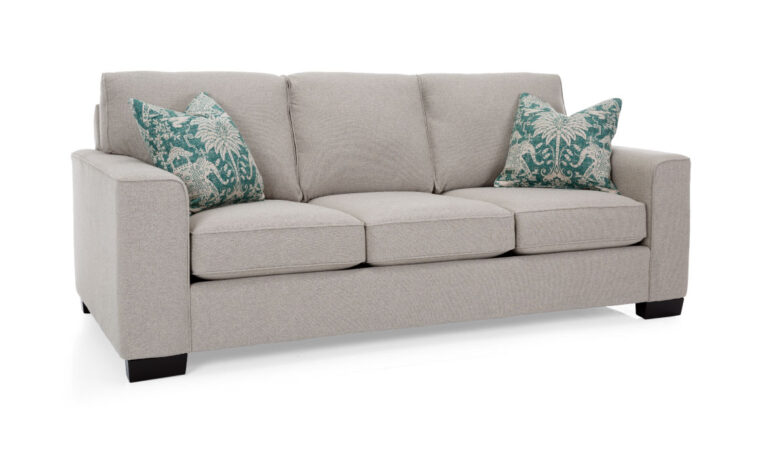2483 sofa is a contemporary sofa in a light grey fabric accented with bright blue pillows and espresso wood legs
