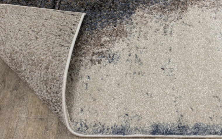Breeze II Area Rug by Kalora - floor rug with marbled design of cream, black, brown, and teal blue (backing)