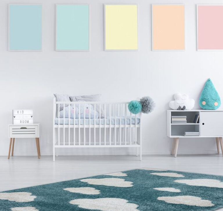 Kalora Kids Cloud 9 Area Rug - blue kids area rug with white clouds - room shot with rug on the floor of a white nursery with colourful decor