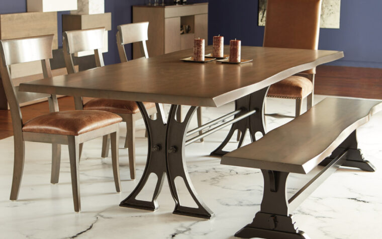 Live Edge Table by Bertanie - industrial metal base supporting wooden table with live edge feature; situated in a dining room with wooden dining chairs and an industrial dining bench