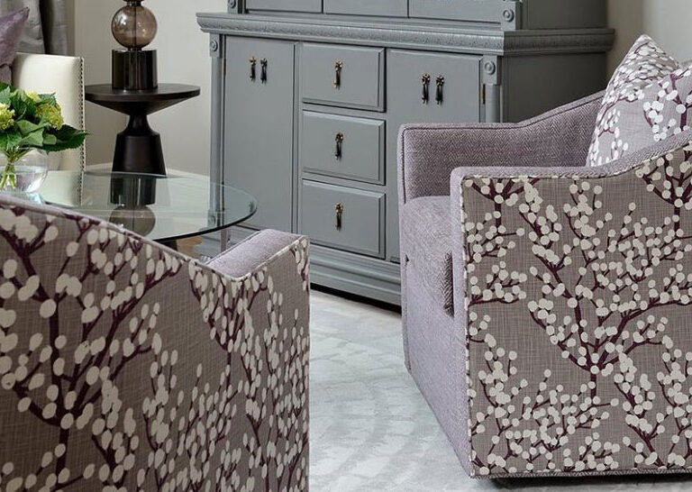 Vogel swivel chairs in mauve combination upholstery - solid mauve fabric on seat and mauve blossoming tree design on sides and back with matching throw pillow