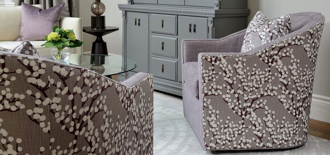 Vogel swivel chairs in mauve combination upholstery - solid mauve fabric on seat and mauve blossoming tree design on sides and back with matching throw pillow