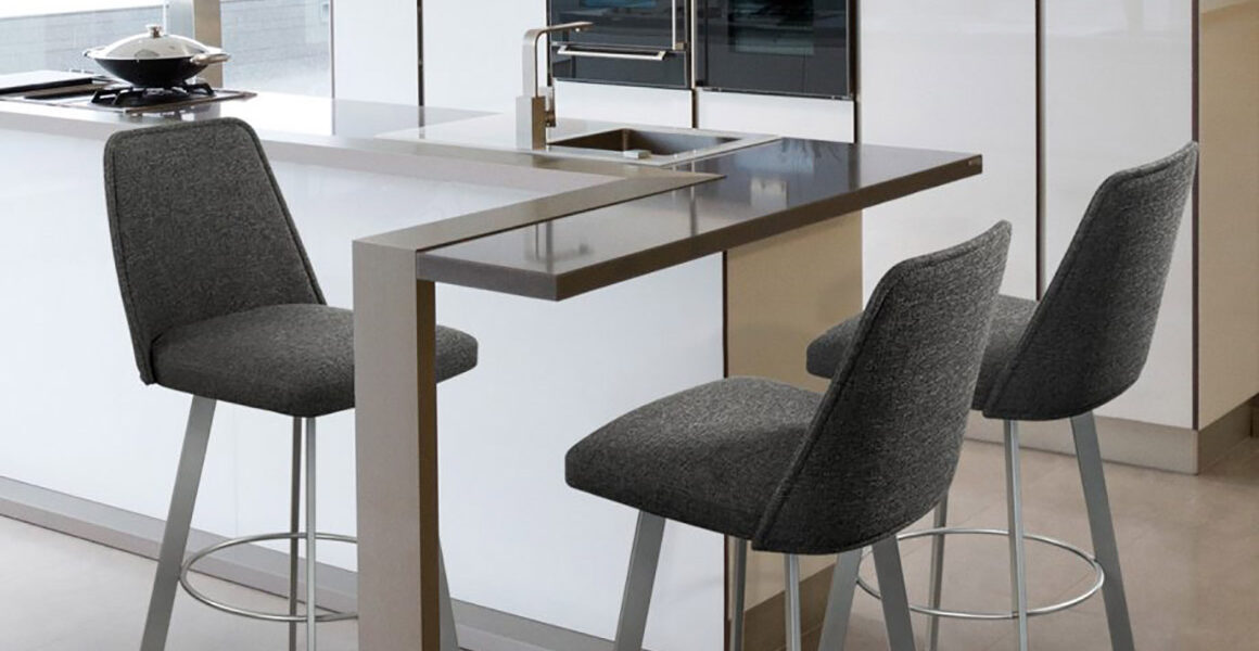 Trica Sofia barstools with full backs upholstered in grey fabric and stationed around a glass-top peninsula in a white, high gloss, condo kitchen