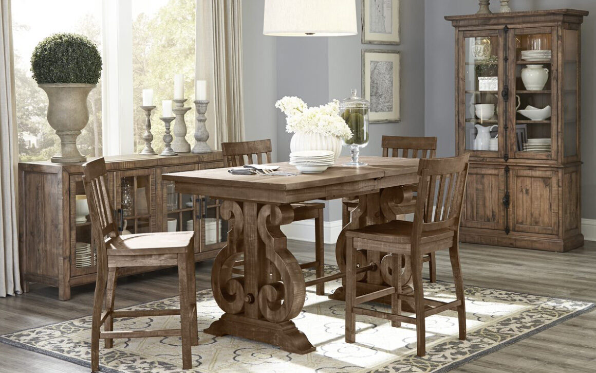 Willoughby Dining Cabinet - Magnussen - pine solids and antique brass hardware with pewter overlay; room shot with 6 wooden chairs around rectangular dining table and dining cabinet behind