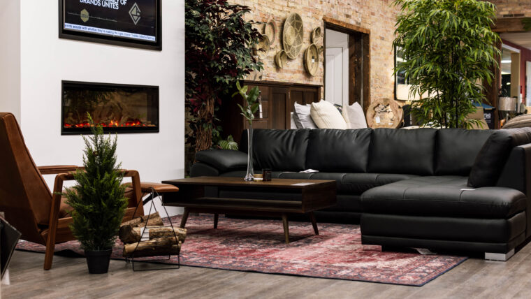 Leather furniture - Oxford & Black Sectional by fireplace on main floor of Chervin Furniture & Design in Elmira