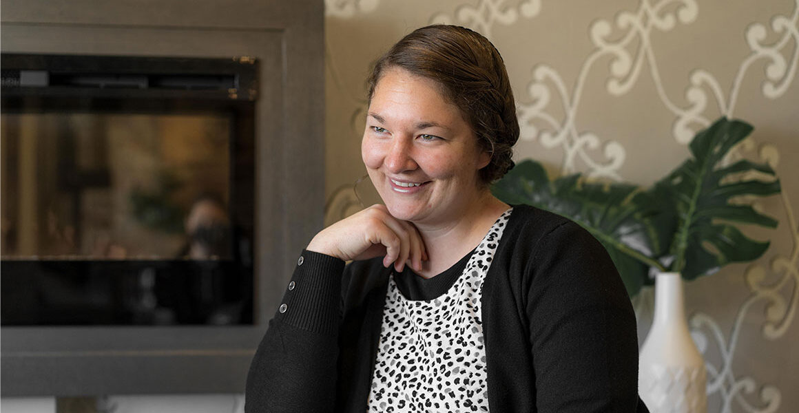 Jody S. sitting by fireplace