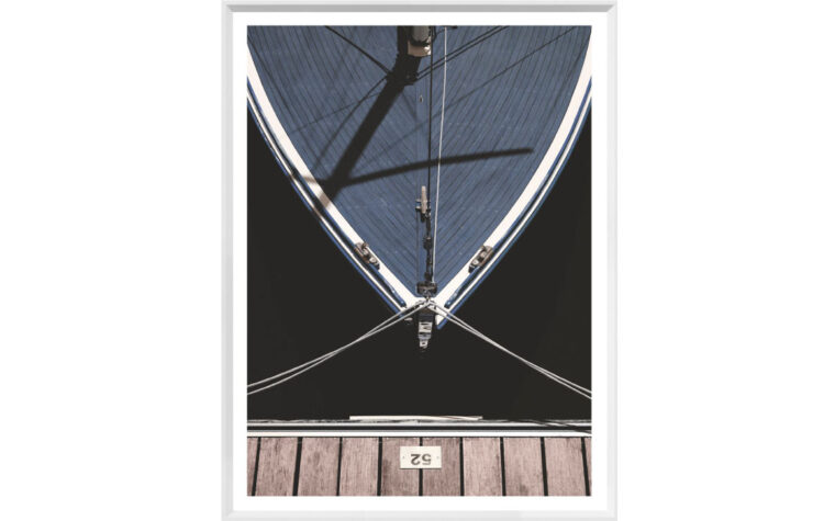 A photograph of a boat tied to a wooden dock