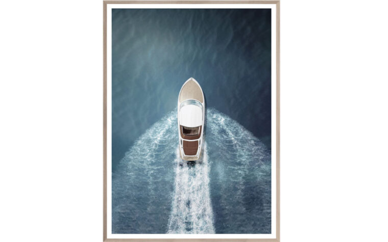 A speed boat on the water with ripples and waves behind it