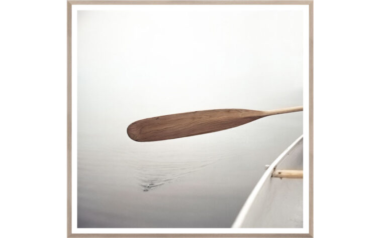 cottage wall art shows a painting of a paddle in a canoe