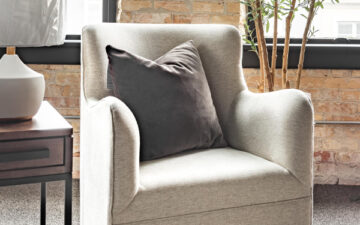Swivel chair with a throw pillow and in natural light