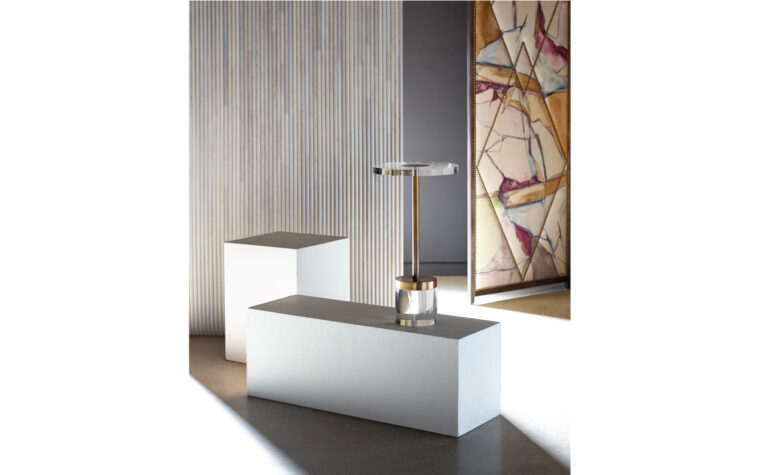 A gold and acrylic martini table in a room