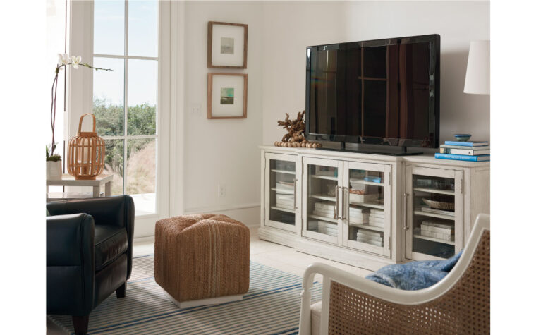 Wood frame entertainment console with glass doors in living room