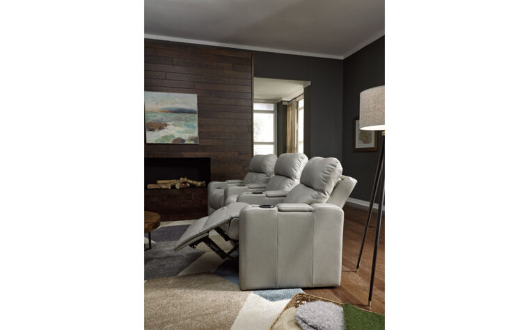 Side view of three theatre seating chairs in living room with recliners extended