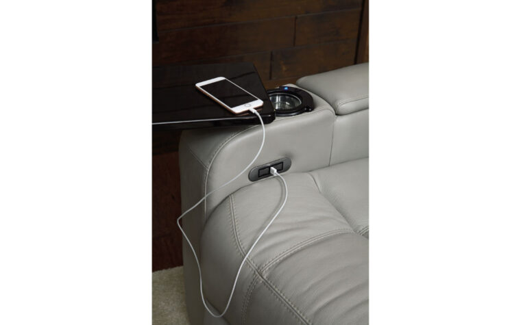 Close up shot of USB port charging phone on theatre seat