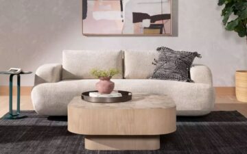 Blanco coffee table by Four Hands styled with curved sofa.