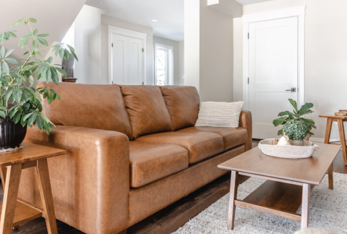 brown leather couch in transitional living room