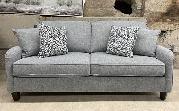 transitional grey sofa with navy pillows