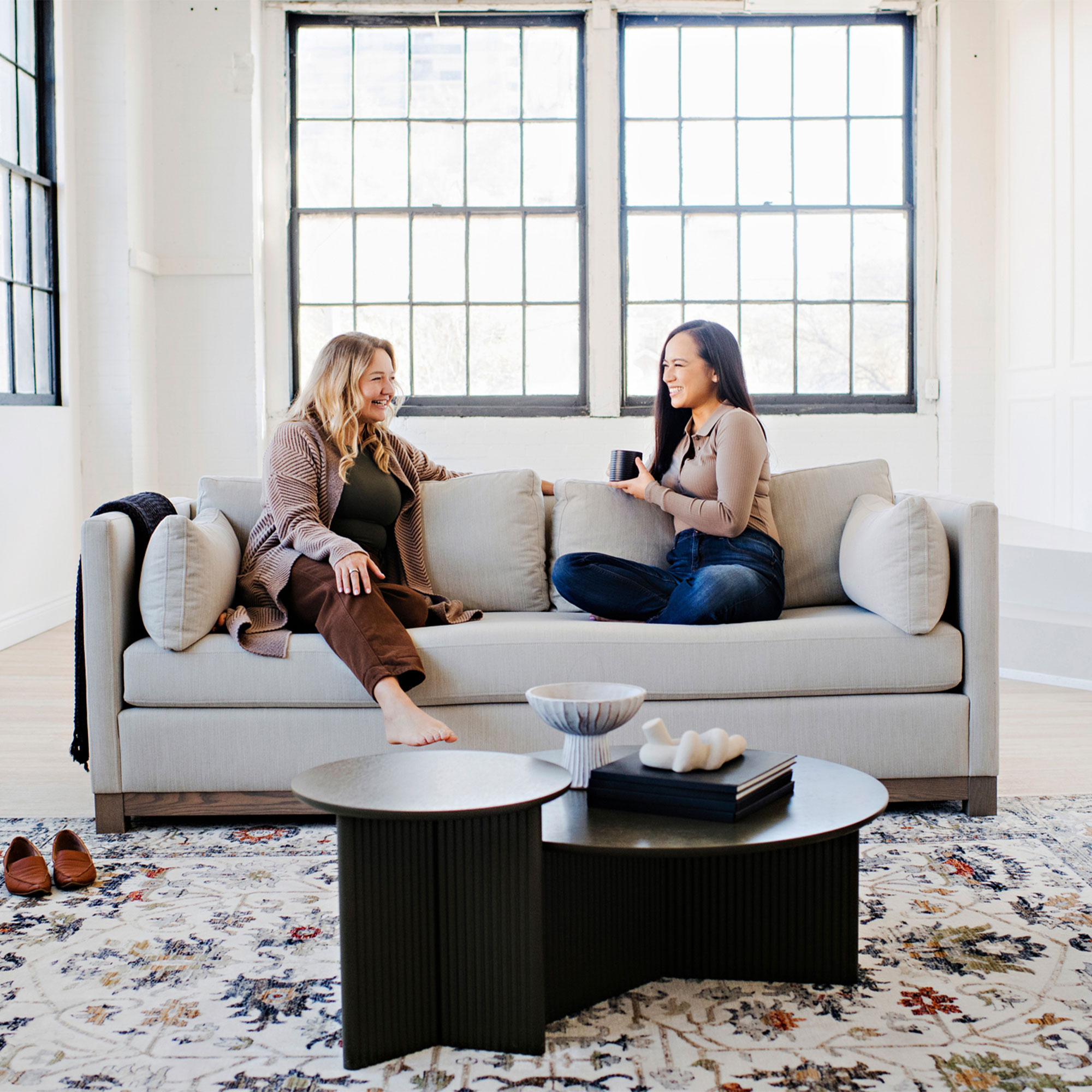 two women on a modern couch in a loft in waterloo