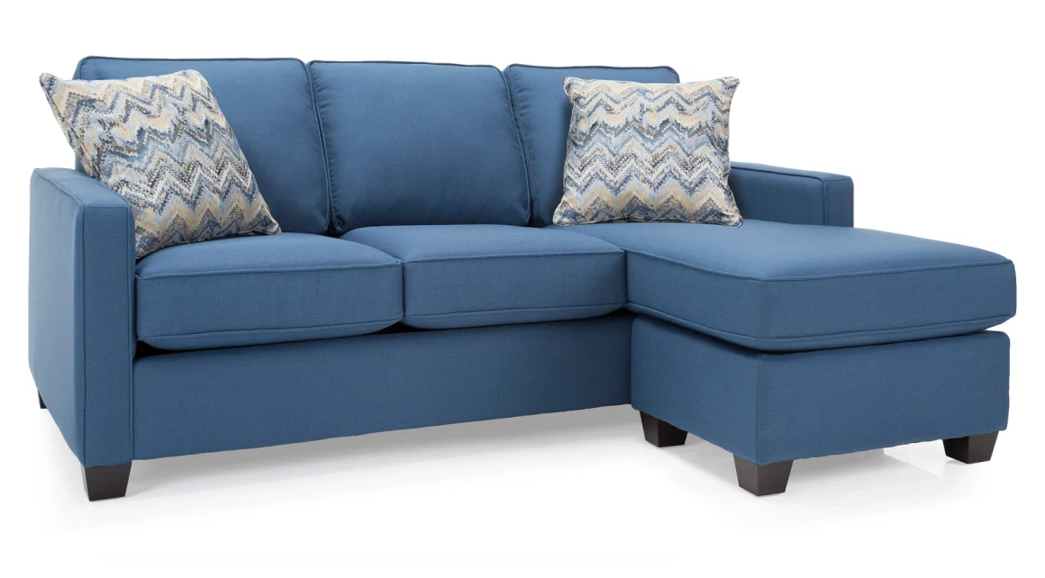 A blue fabric sofa with chaise and patterned accent pillows.