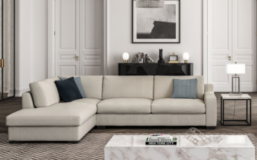 A greige sectional sofa with blue toss pillows in a modern luxe living room. Brentwood offers custom furniture in Ontario with an emphasis on the environment. 