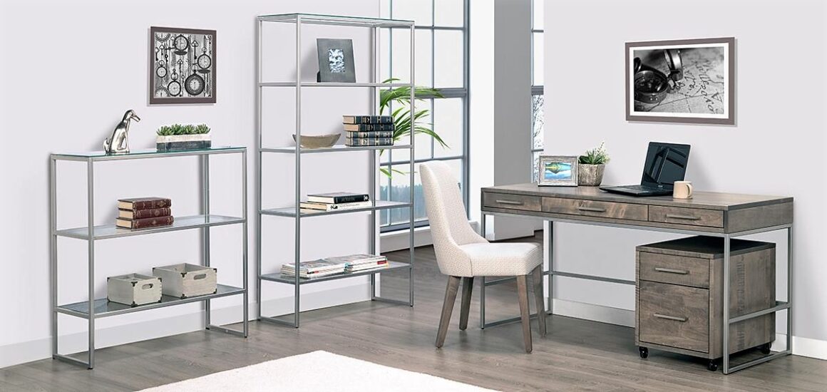 A office with silver metal and glass shelving, a wooden desk, and beige chair