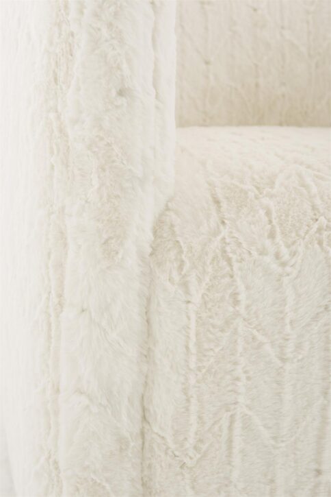 A swivel barrel chair detail shot showcasing a cream chervon faux fur.