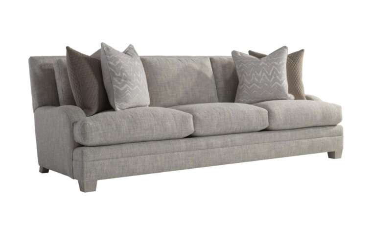 Angled view of the Rollins transitional sofa by Bernhardt with low-profile arms in gray fabric with gray and brown throw pillows on either side