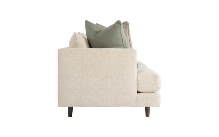 Side view of the Colette stylish modern sofa by Bernhardt in cream fabric with two green throw pillows on either side