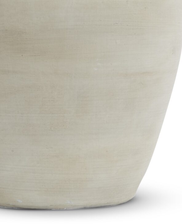 An organic table lamp with a textured cream ceramic base.