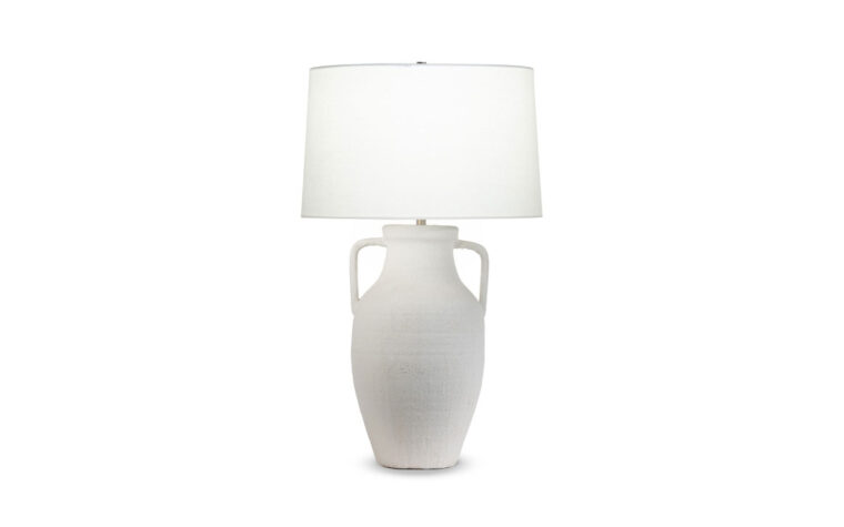 The classic Delilah Tapered Table Lamp with textured white ceramic base and off white linen lamp shade with the light on