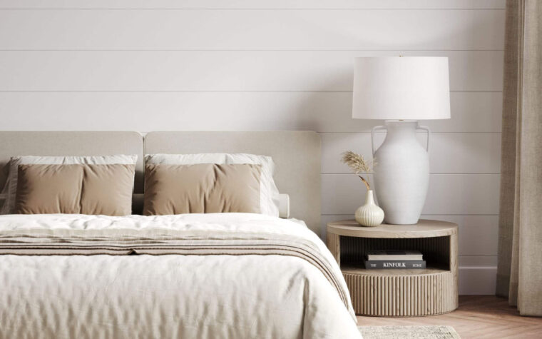Plush white and brown bed with the classic Delilah tapered table lamp on a nightstand beside it