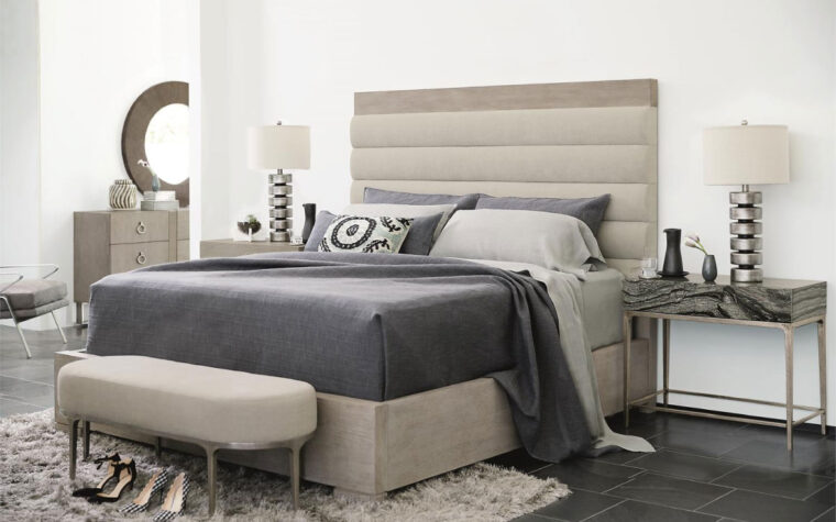 A Black forest marble night stand from Bernhardt with cast aluminum legs. in a bedroom setting